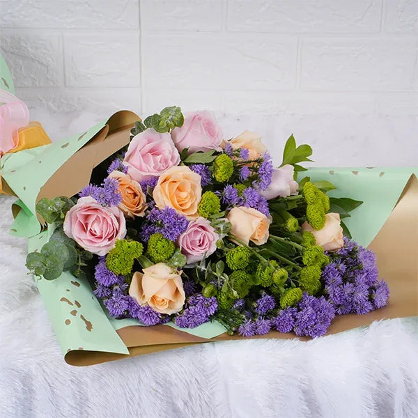 flower bouquet of peach roses sweet pink roses blue daisy close up view