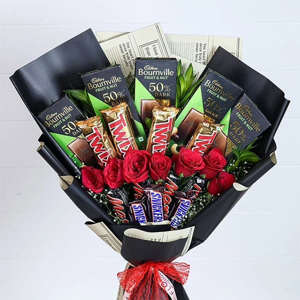 chocolate bouquet with red roses wrapped in black paper close up view