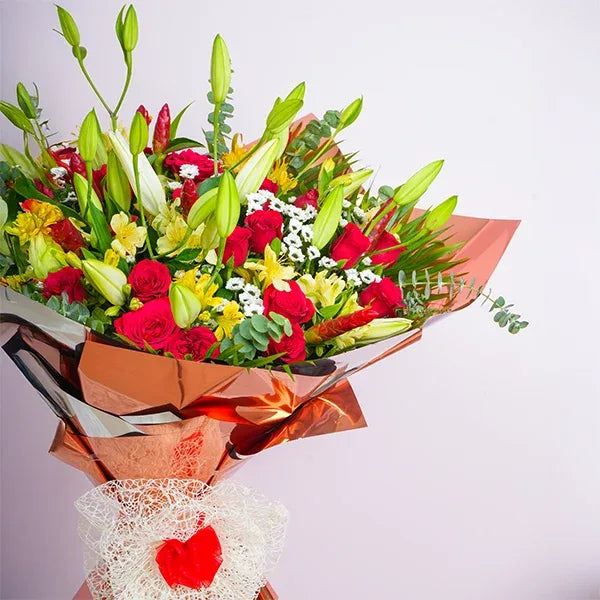 mix flower bouquet of red roses with oriental lilies close up view