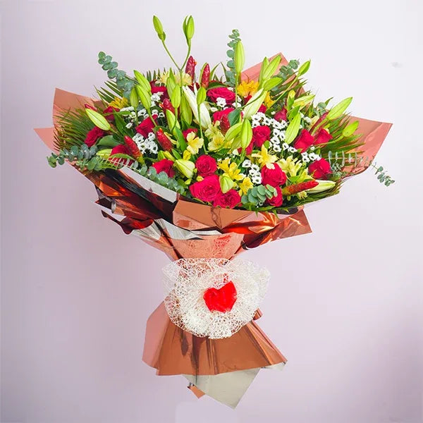 mix flower bouquet of red roses with oriental lilies front view