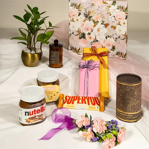 curated hamper with artisanal chocolates and aromatic candles open view