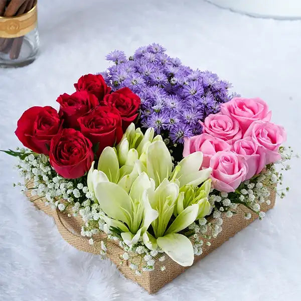 red revival roses blue daisies and lilies in a jute box front view 2
