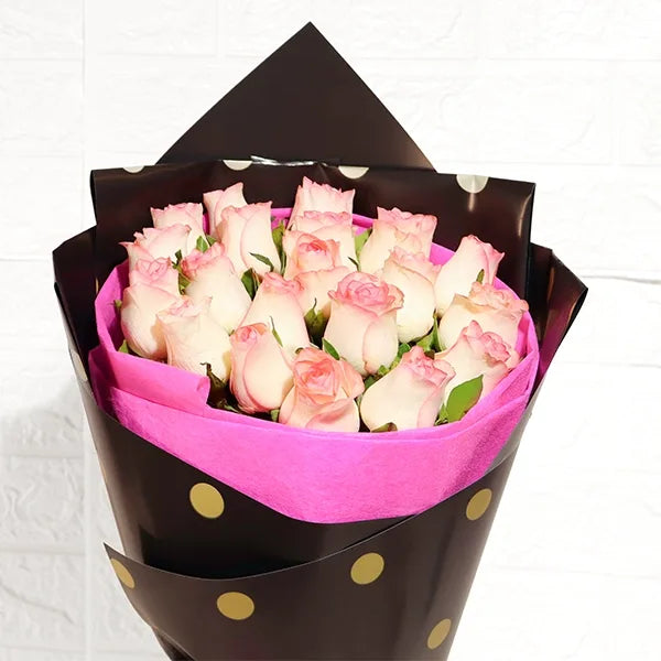 elegant jumilia pink rose bouquet in pink and black wrap closeup