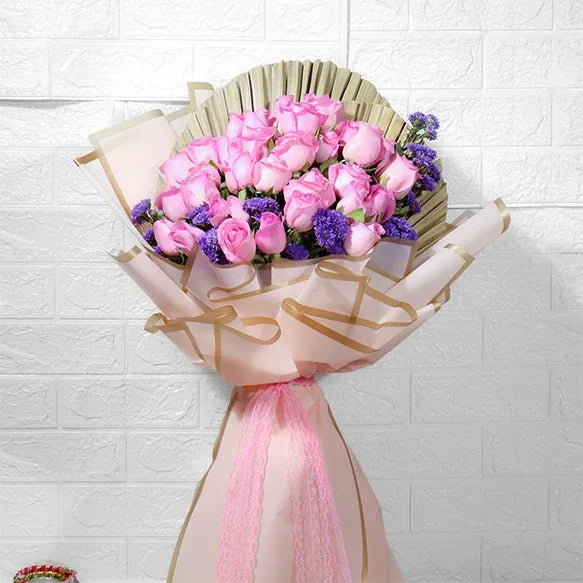elegant pink roses bouquet with blue daisy closeup view