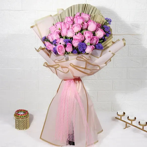 elegant pink roses bouquet with blue daisy front view