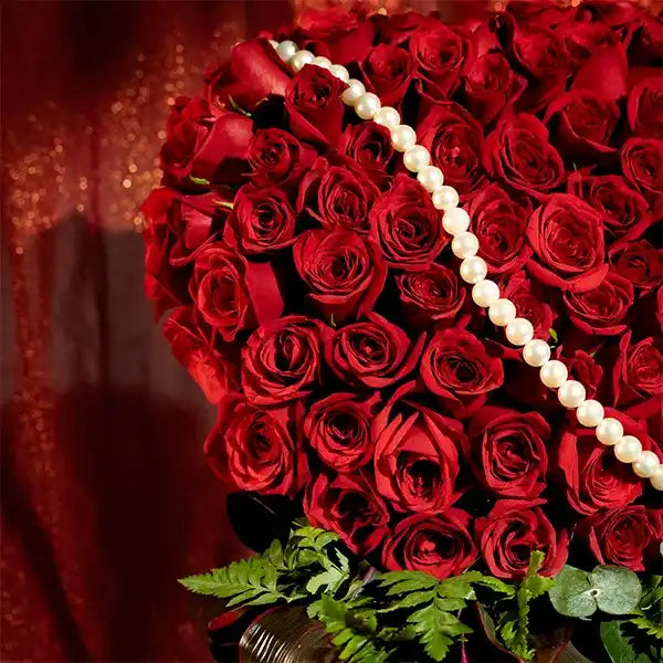 70 red roses in green leather box close up view