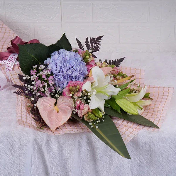 white oriental lily stems hydrangea anthurium bouquet close up view