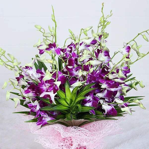 orchid bouquet with pink mash paper front view