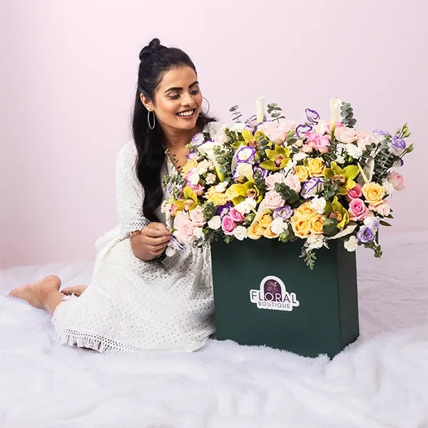fancy flower box arrangement of roses and lilies closeup view