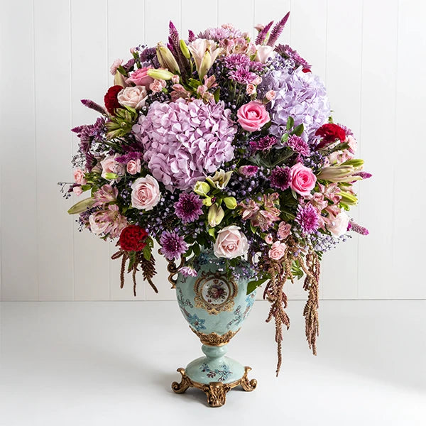 fancy flower vase arrangement of hydrangea asiatic lily pink roses front view