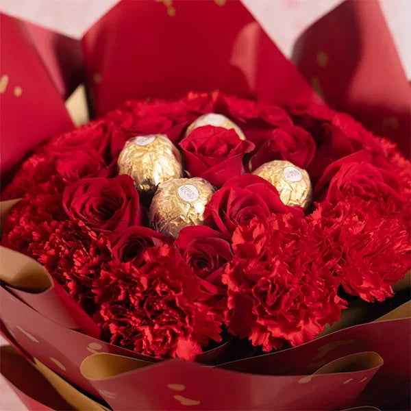chocolate bouquet of red roses and red carnations with ferrero rocher close up view 2