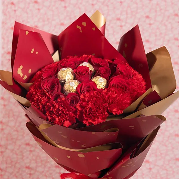 chocolate bouquet of red roses and red carnations with ferrero rocher close up view