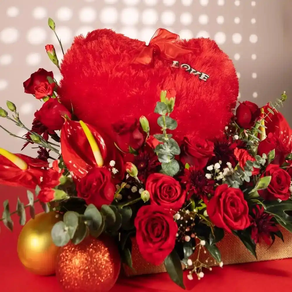 red flowers heart cushion in jute close up