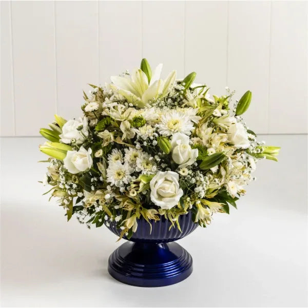 flower vase arrangement of asiatic lily white chrysanthemum close up view