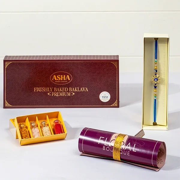 golden evil eye sun rakhi with asha baklava & roli chawal front view