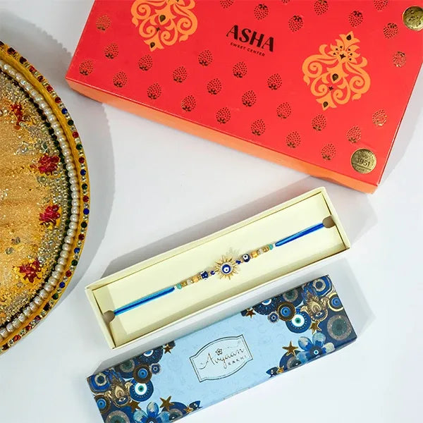 golden evil eye sun rakhi with asha sweets 500g front view