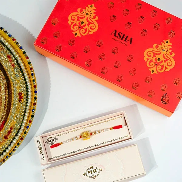 golden monogram ganpati rakhi with asha sweets 500g front view