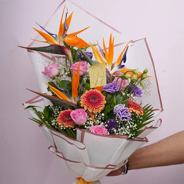 mix flower bouquet of pink roses bird of paradise close up view