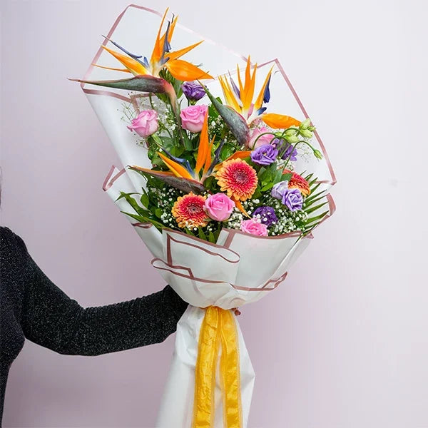 mix flower bouquet of pink roses bird of paradise front view