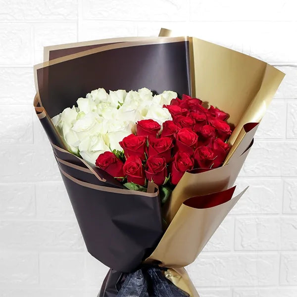 graceful red and white roses bouquet with kamini leaf touch  close up view