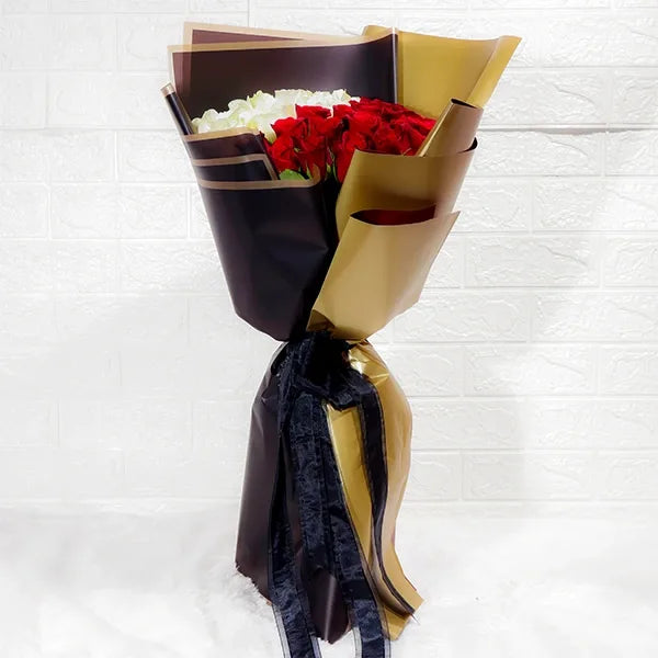 graceful red and white roses bouquet with kamini leaf touch front view