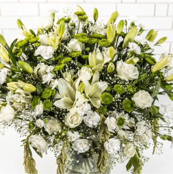 white rose asiatic lily white green button chrysanthemum in a glass vase top view