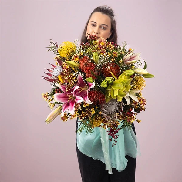 luxurious oriental lily and king protea flower arrangement top view