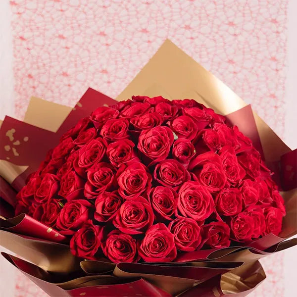 100 red roses bouquet wrapped in red and gold paper top view