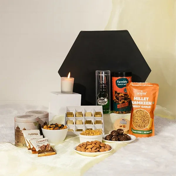 luxury perfume hamper for him with chocolates and snacks front view