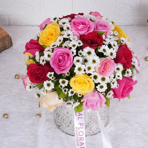mix roses with white santoni in a sliver glass vase top view