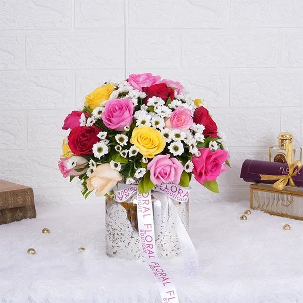mix roses with white santoni in a sliver glass vase front view