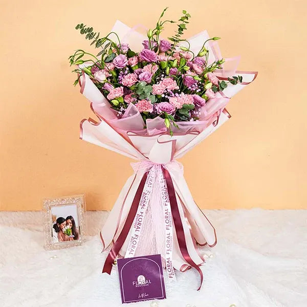 mixed bouquet wrapped in pink for mothers day front view 2