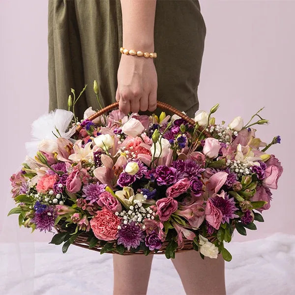 mixed flower basket of pink alstroemeria Eustoma asiatic lilies purple shaded spray carnations front view