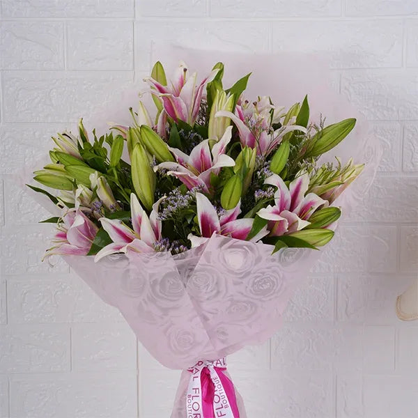 oriental lily bouquet warped in pale pink paper front view 2