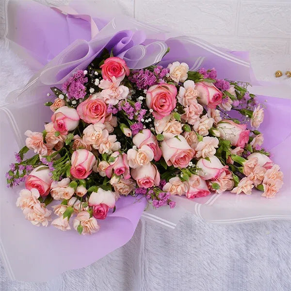pink roses bouquet with spray carnations closeup view 3
