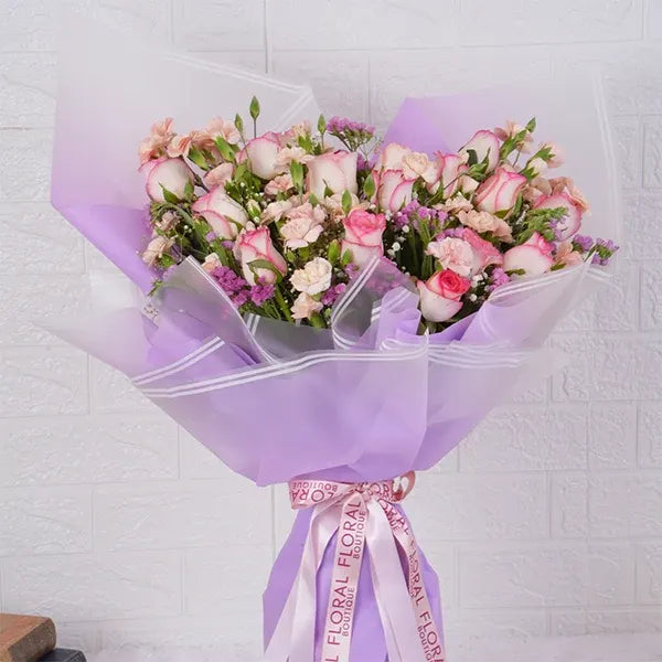 pink roses bouquet with spray carnations closeup view