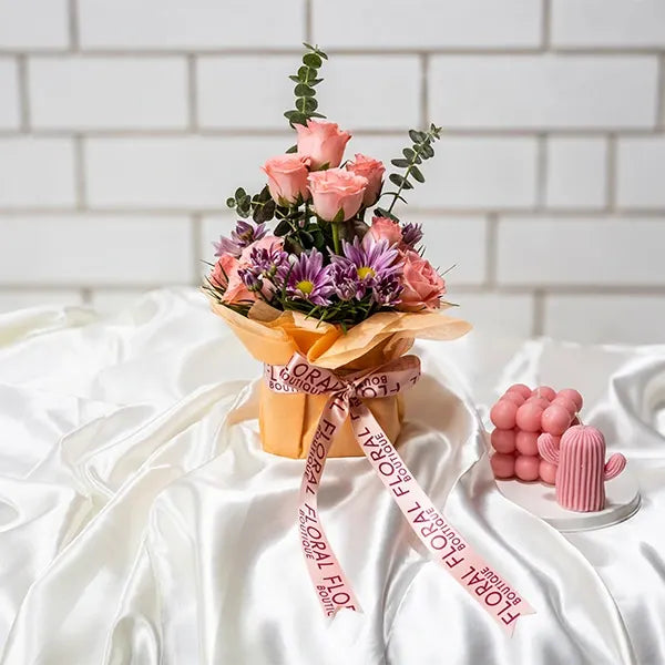 baby pink roses with chrysanthemums in a square glass vase front view