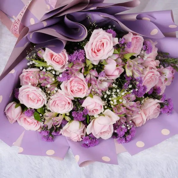 bouquet of pink roses alstroemeria and gypsophila top view