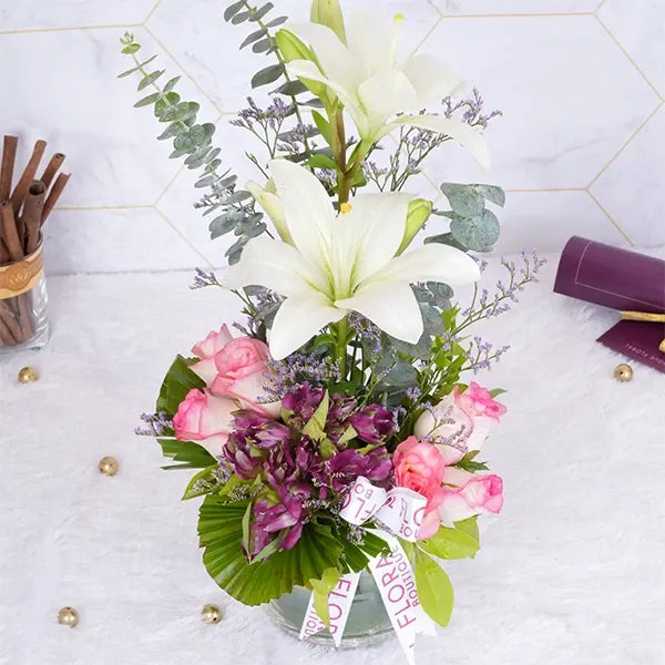 lilies roses alstroemeria in glass pot closeup view