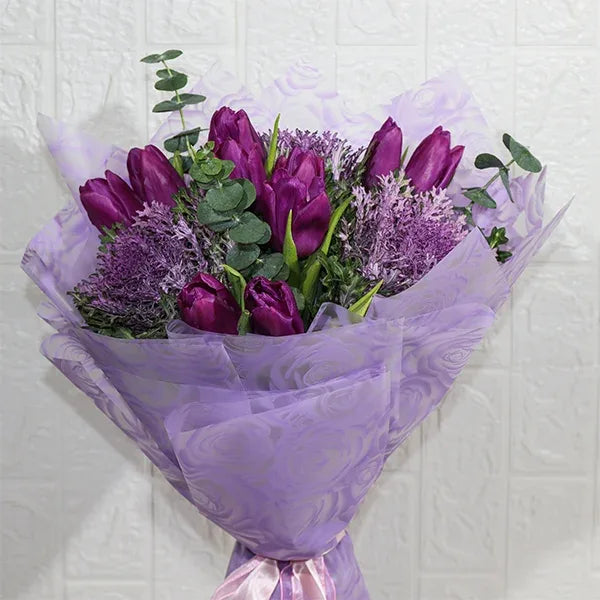 purple tulips bouquet with brassica close up view