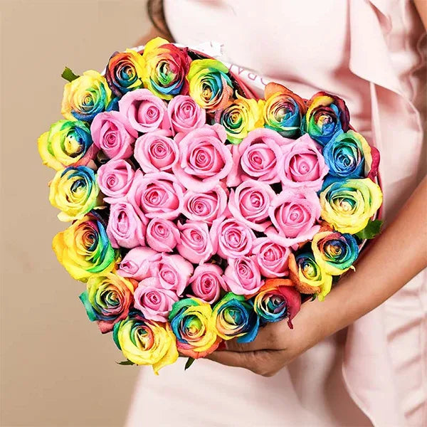 rainbow roses in romantic heart shaped red box close up view