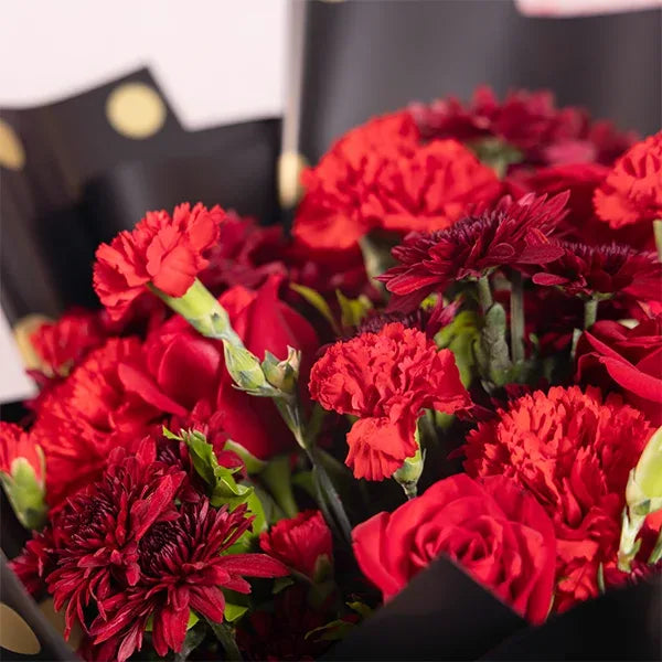 bouquet of red chrysanthemums carnations and roses close up view 2