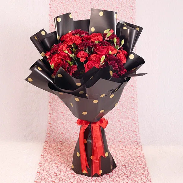 bouquet of red chrysanthemums carnations and roses front view