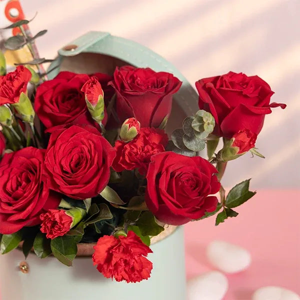 red roses flowers and chocolate in a light blue box close up view 2