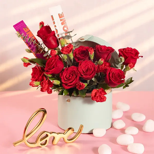 red roses flowers and chocolate in a light blue box front view