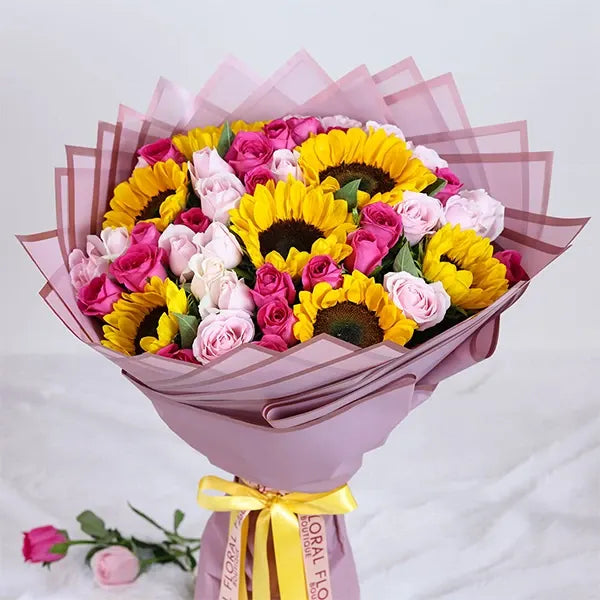 sunflower and pink rose bouquet with purple wrap close up view