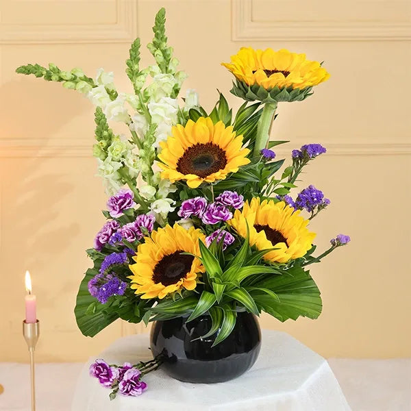 sunflowers in black glass pot close up view