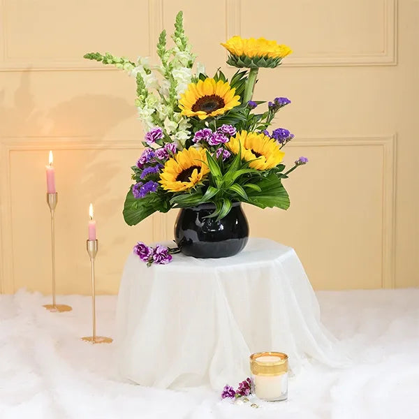 sunflowers in black glass pot front view