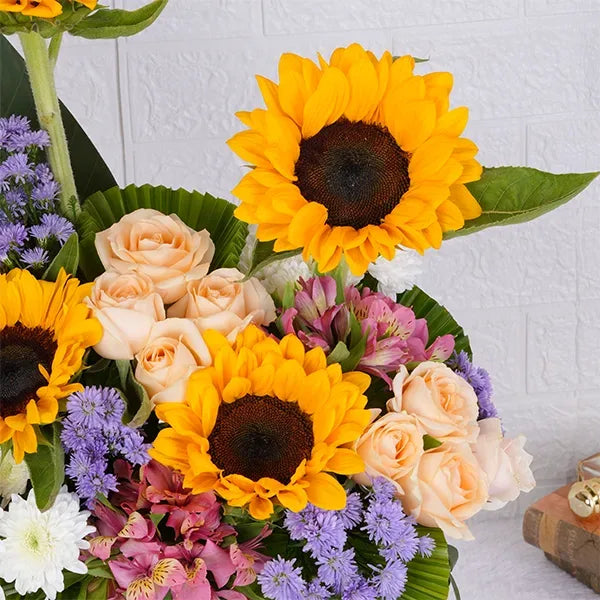 sunflowers peach roses white chrysanthemums in a glass cone arrangement close up view  2