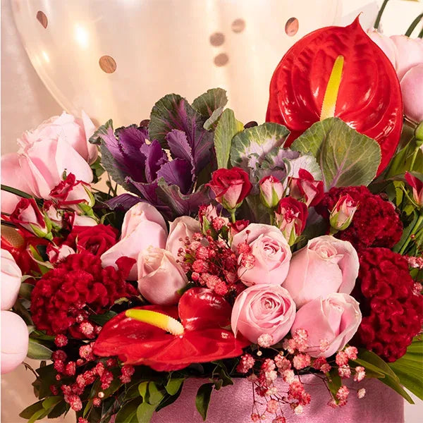pink box with balloons red and baby roses celosia close up view 2